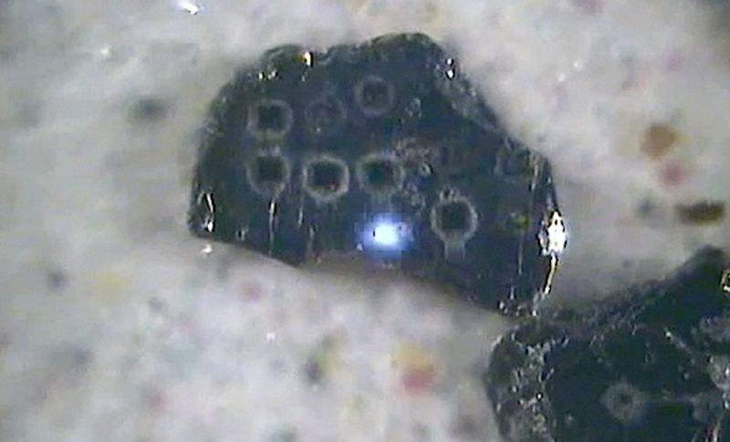 In-situ dating of a biotite flake using the pulsed UV laser.