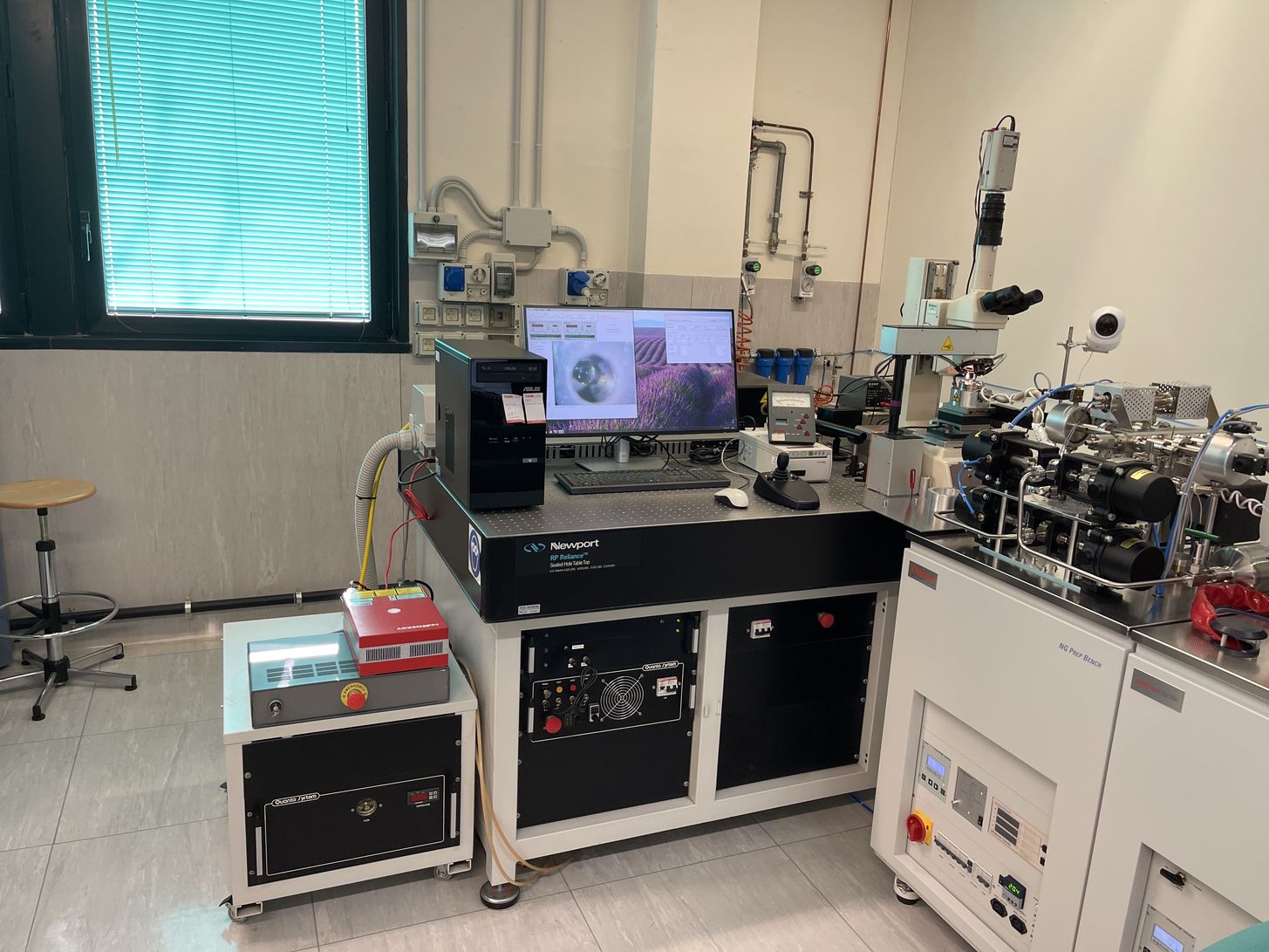 The UV laser probe (Nd:YAG) and the IR laser (Fiber laser), beam optics and the microscope.