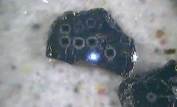 In-situ dating of a biotite flake using the pulsed UV laser. In-situ dating of a biotite flake using the pulsed UV laser.