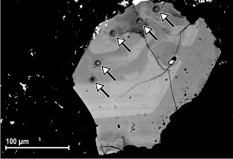 SEM-BSE image of phlogopite VUT191_11 (Mt. Vulture, Southern Italy) after removal of Pt-coating used for ion-probe analysis. The SIMS craters are indicated by the arrows. The contrast due to the chemical inhomogeneity is clearly visible (Scordari et al., 